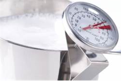 milk frothing thermometer in jug of milk