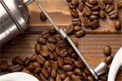 coffee grinder in amongst coffee beans 