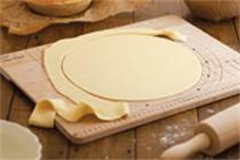 pastry being cut on a pastry cutting board