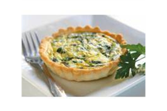 quiche on a small plate with a afork