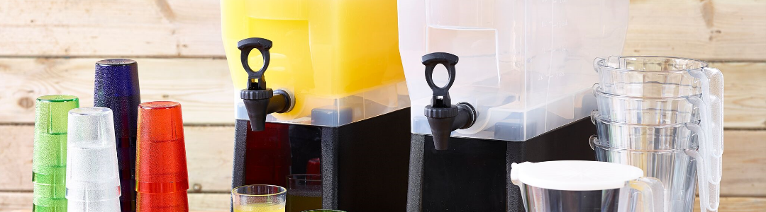 two drinks dispenser, one filled with orange juice, plastic cups also on table