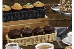 two rectangular baskets containing blueberry and chocolate muffins 