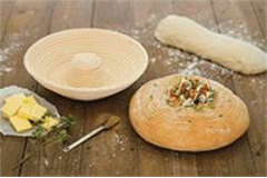 bread making basket and bread on wooden table top