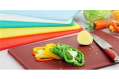 array of rectangular chopping boards with sliced peppers on