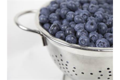 colander with blueberries in