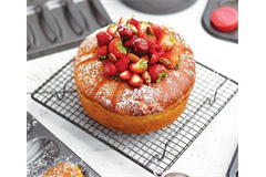 large cake on round square cooling tray