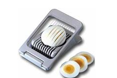 an egg being sliced by a egg slicer 