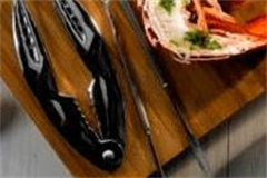 fish tweezers on board of fish utensils