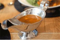 metal gravy boat containg gravy 