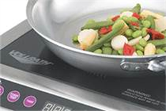 vollrath induction hob with fry pan on - cooking veg