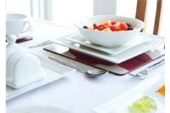 Dessert serve in large white bowl on top of two square plates on a table top 