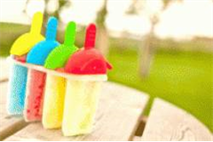 4 different flavoured lollies in lolly moulds, on a park table 