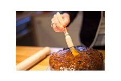 wooden pastry brush brushing a cake 