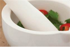a pestle and mortar with condiments inside 