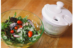 salad spinner next a bowl of salad