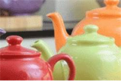 three different coloured tea pots 