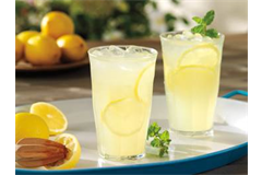 tumblers filled with a lemonade drink accompanied by lemons 
