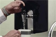 water boiler dispensing water into a cup 