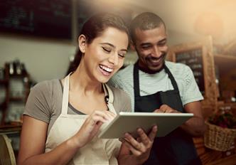 two store owners using our website on a portable tablet