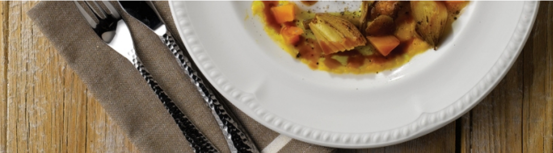 round white plate with knife and fork placed beside 