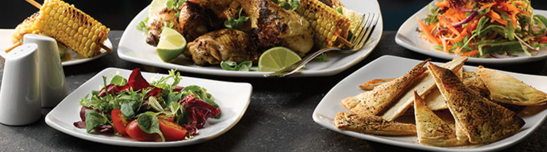 white rectangular plates filled with a variety of foods 