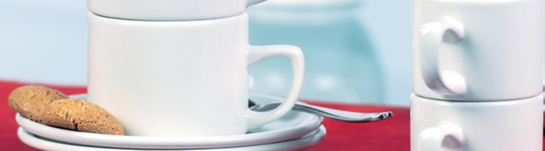 stacked tea cups with saucer and biscuits