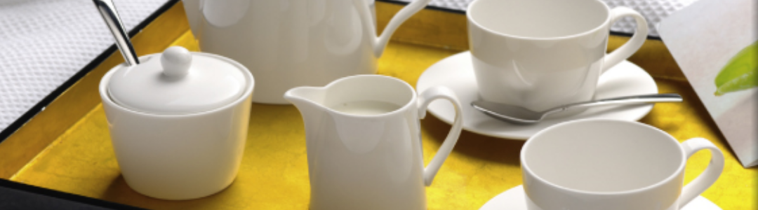 a variety of china cups and milk jugs 