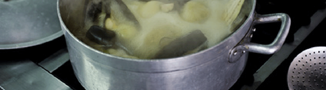 catering size aluminium pot on stove boiling potatoes