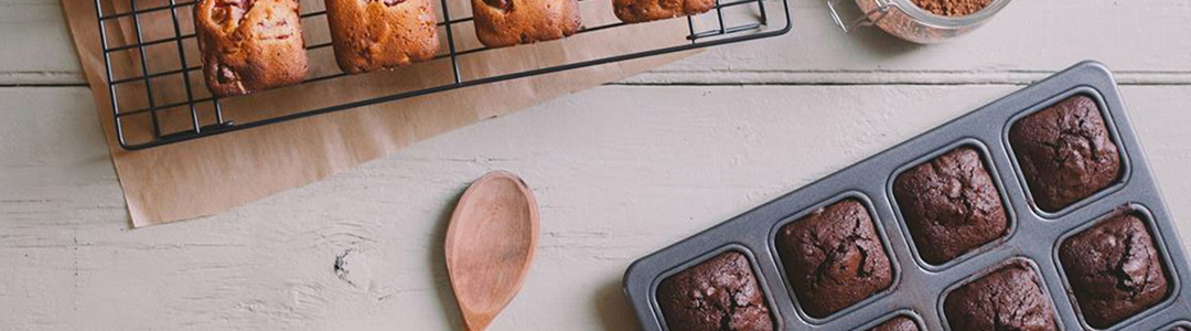 brownie pan full of chocolate brownies alongside a cooling tray