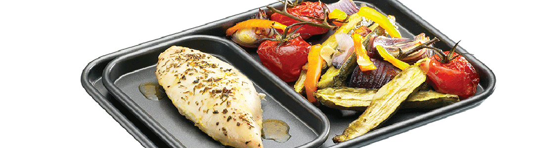 one large, one small baking tray full of cooked food from the oven 