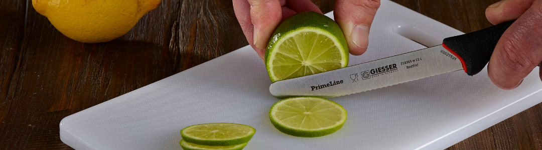 bar board with man cutting a lime