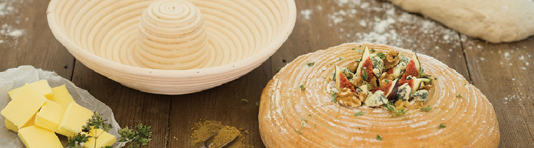 bread making basket and bread on wooden table top