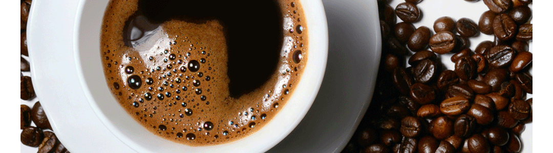 coffee in a cup with saucer amogst coffee beans 