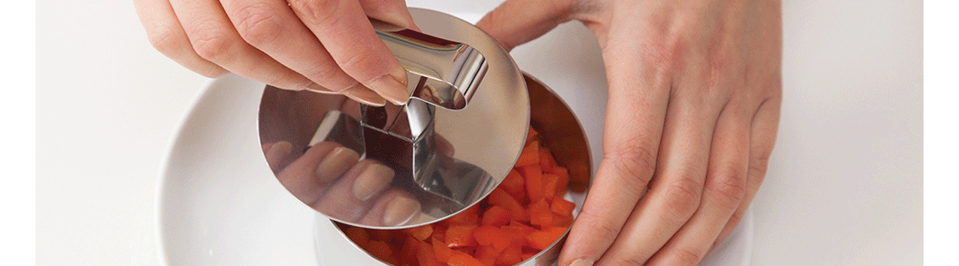 silver cooking ring filled with chopped carrots
