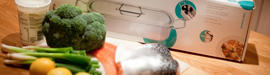 fish kettle on kitchen work top  with piece of raw fish and vegetables 