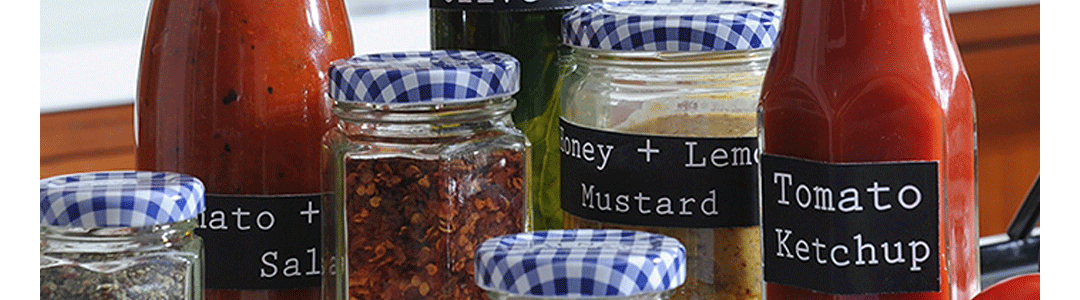 a range of glass bottles filled with a variety of condiments 