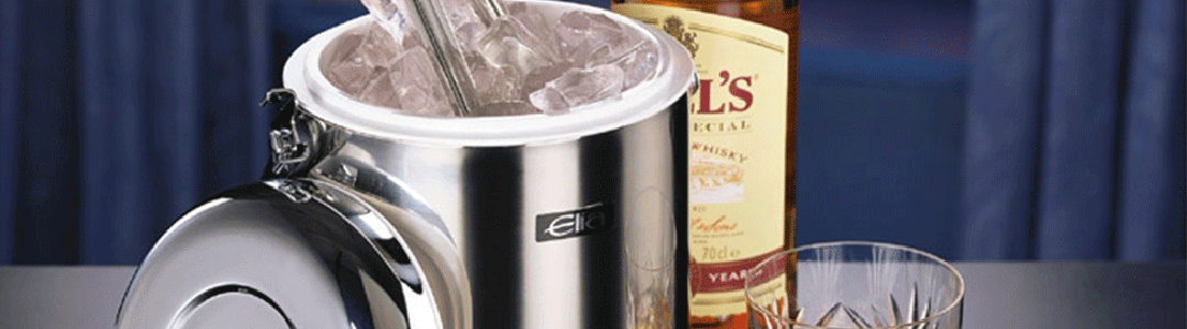 ice bucket filled with ice next to bottle of whisky