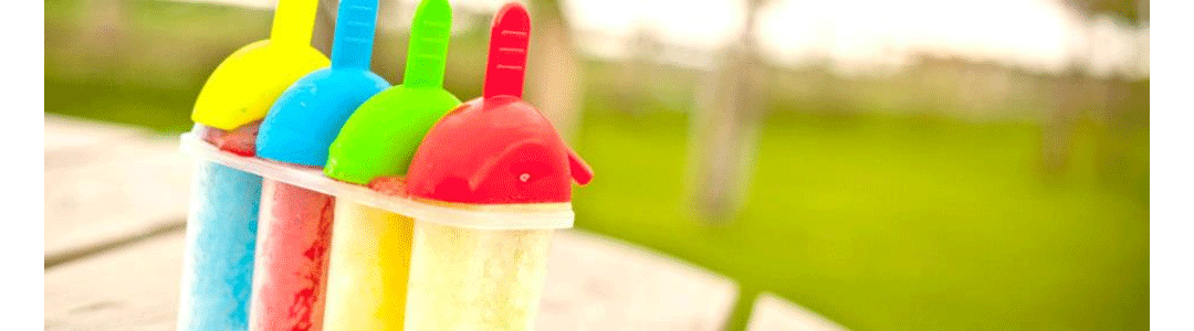 4 different flavoured lollies in lolly moulds, on a park table