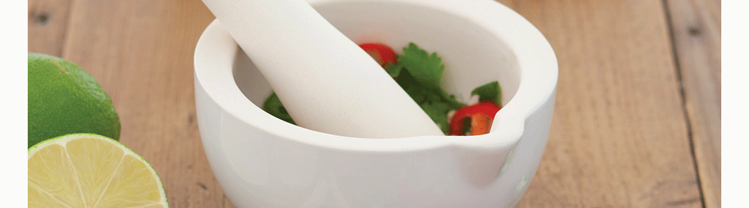 a pestle and mortar with condiments inside