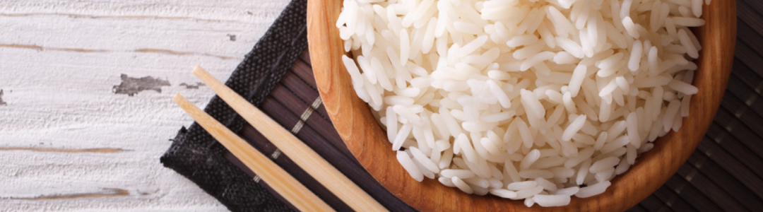 wooden bowl filled with rice, chop sticks