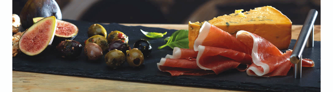 a long rectangular slate with handle holding various foods