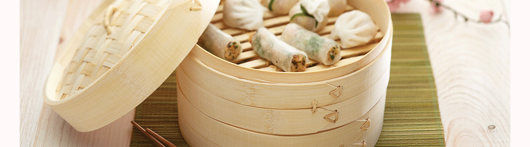 Chinese bamboo steamer containing pancakes 