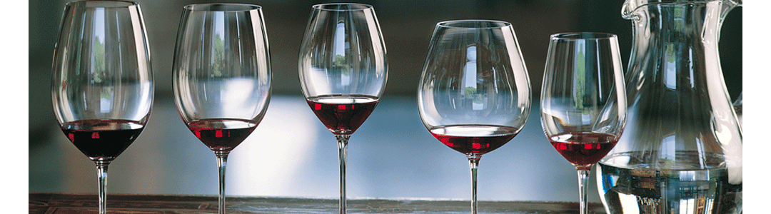 A series of elegant wine glasses in a row each containing red wine 