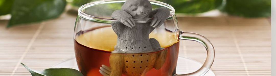 Sloth slow brew tea infuser in a glass tea cup  