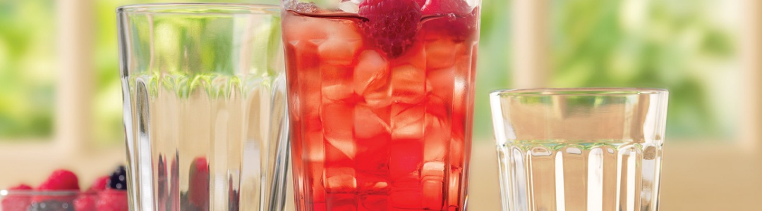tumblers with drink and raspberries 