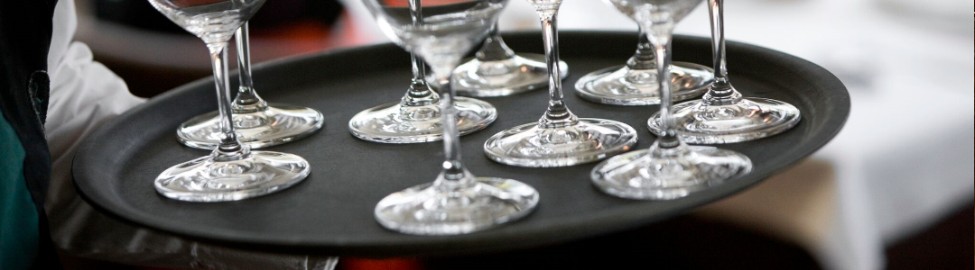 waiter carrying circular tray with drinks on 